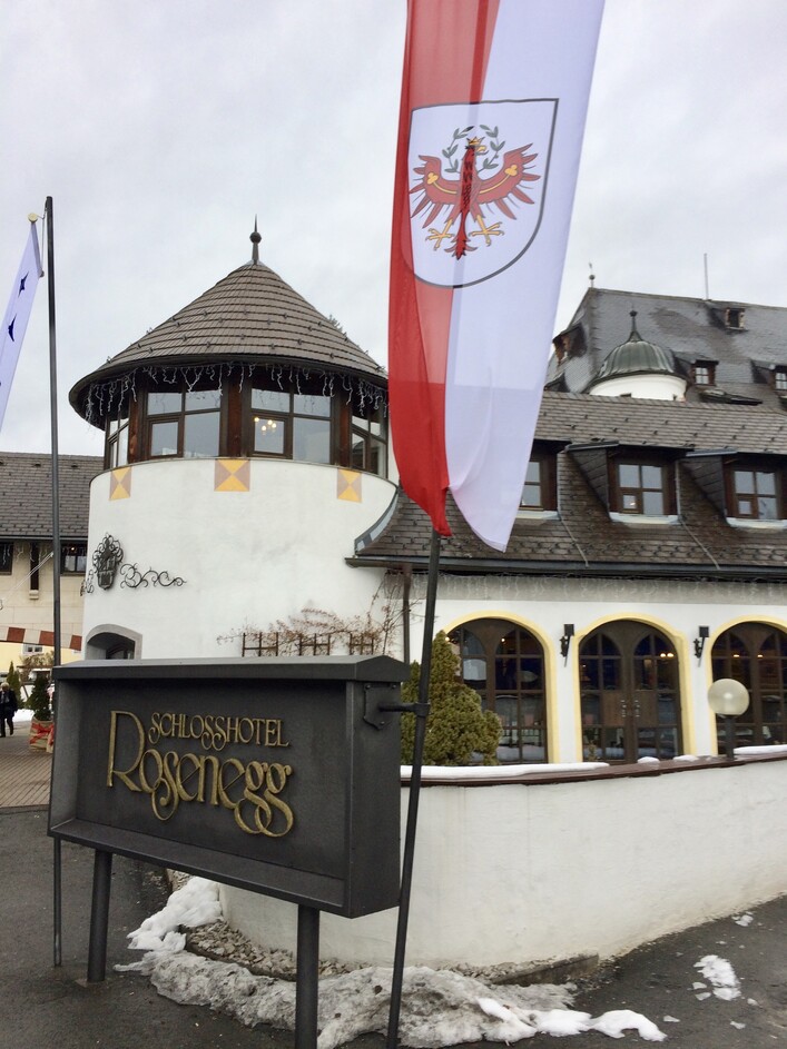 Entrance to the hotel with an Austrian flag.
