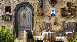 Eingangsbereich des alten Heimathauses am Irrsee mit Stühlen und Tisch neben der Tür.