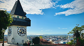 a clock tower on top of a building with a sky background