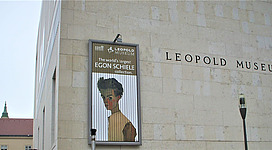 A photo taken in 2008 of the Vienna Leopold Museum, featuring a banner of the Egon Schiele collection