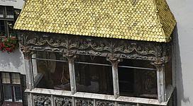 A tall building with a yellow roof and windows