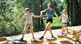 Drei Frauen balancieren über den Parkour des Fit & Fun am Rannastausee