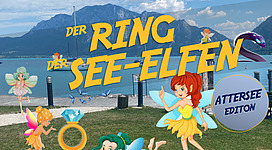 Outdoor Escape in Unterach am Attersee in Unterach am Attersee: Das Bild zeigt eine Szene mit zahlreichen fantastischen Figuren wie Feen, Meerjungfrauen und andere märchenhafte Wesen. Sie sind umgeben von Bergen, Wasser und blauem Himmel mit Wolken. Es scheint sich um eine touristische Attraktion oder ein Themengebiet zu handeln.
